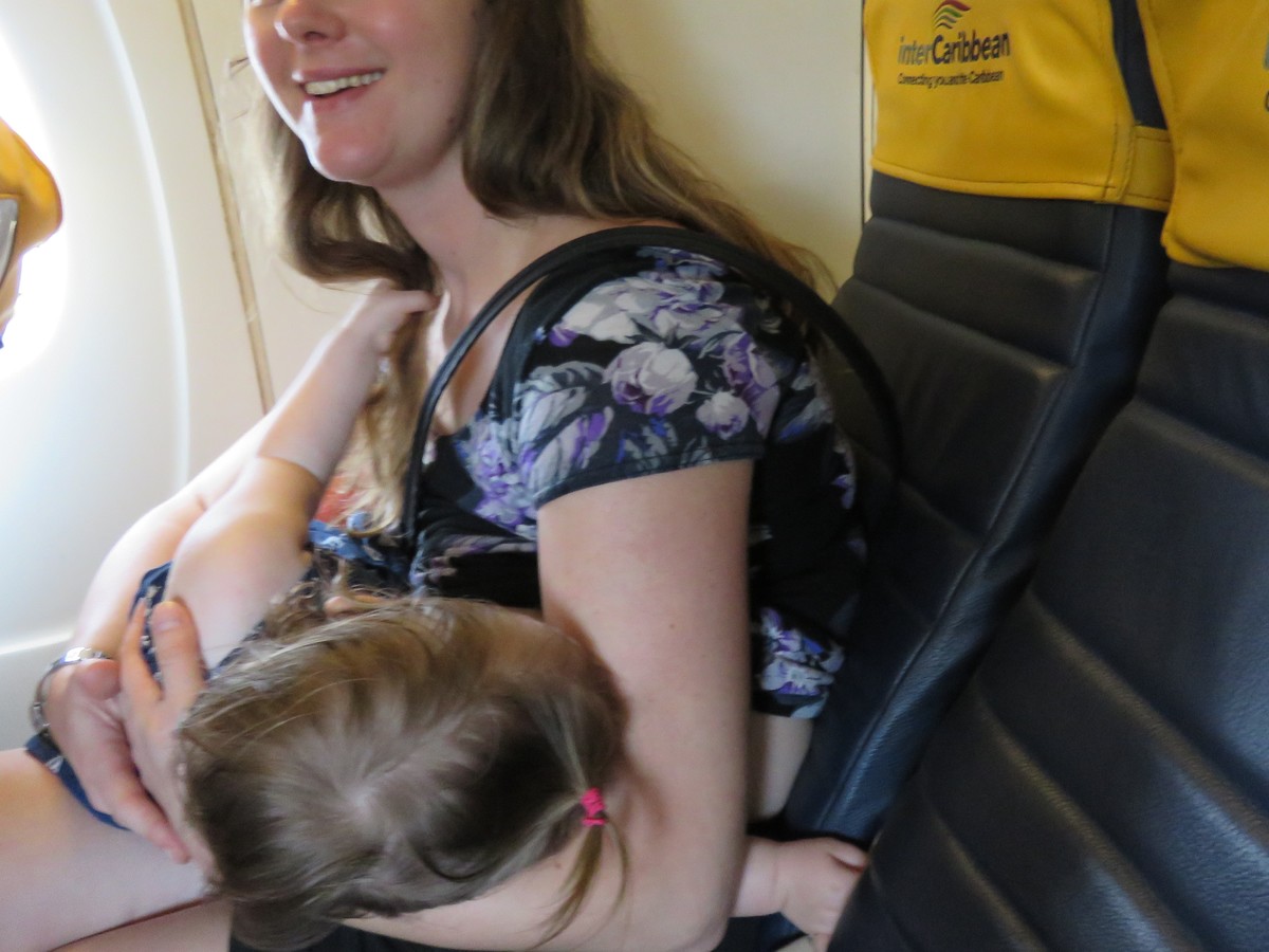 Breastfeeding baby Zizi on an inter island flight in the Caribbean