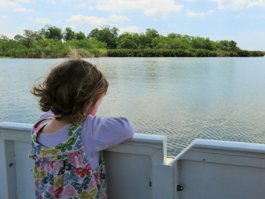 Girl staring out across water