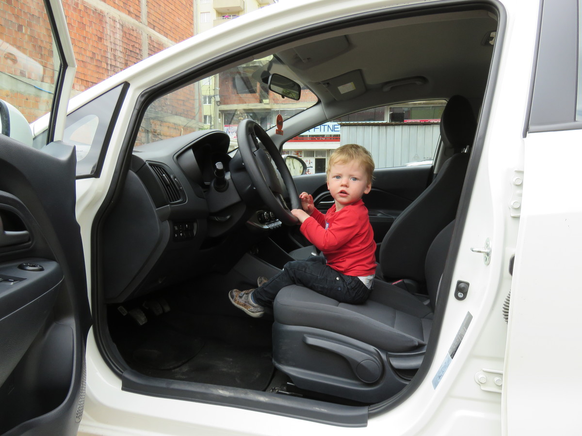 Toddler at wheel of a hire car