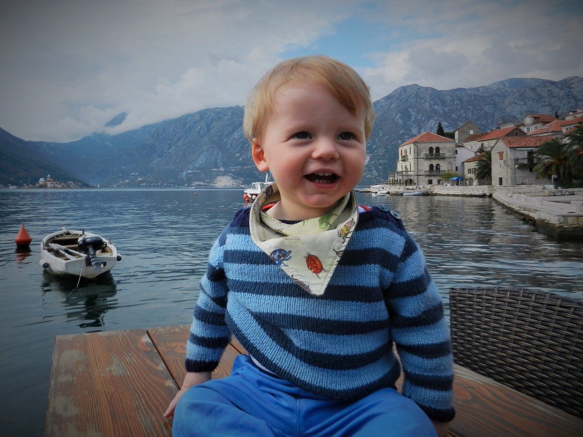 Toddler H smiling in Bay of Kotor