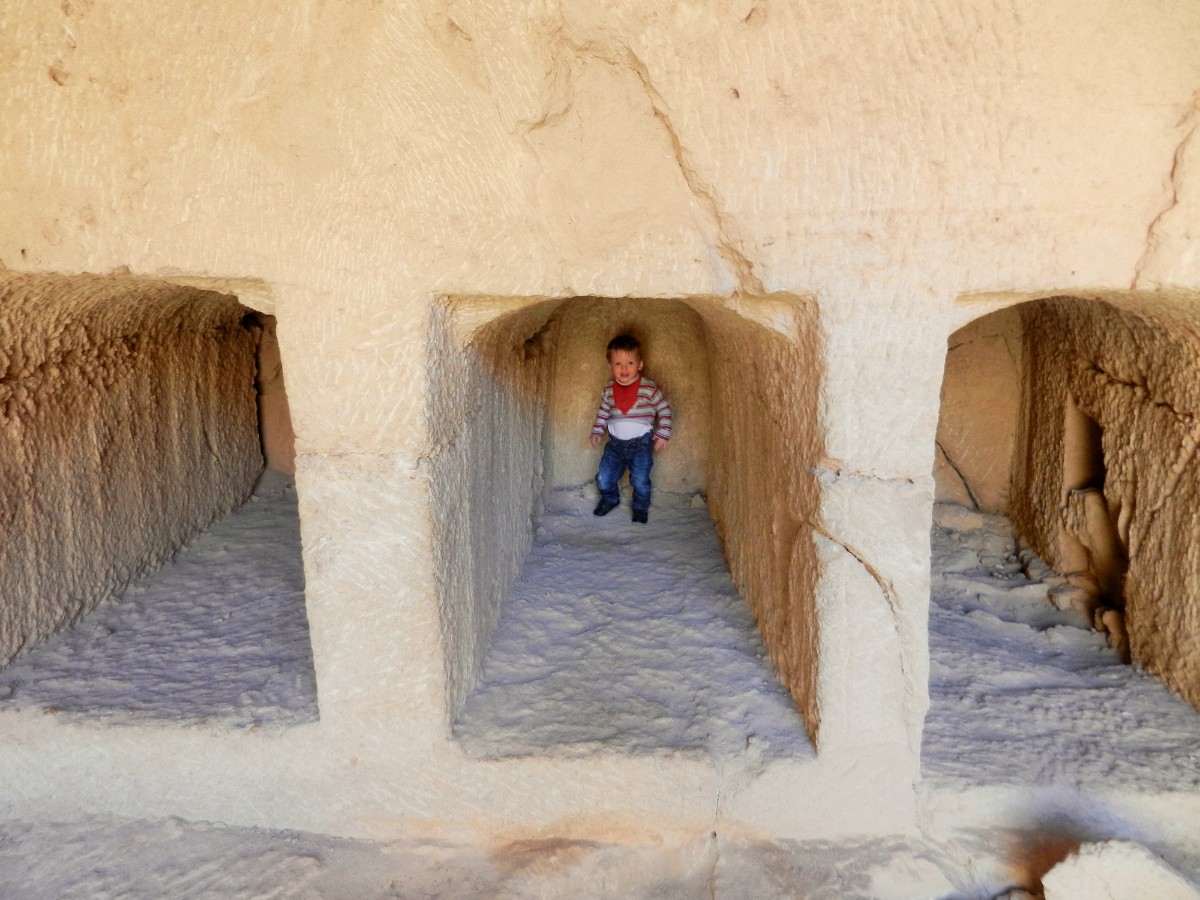 Toddler in burial chambers at Tomb of the Kings, Cyprus