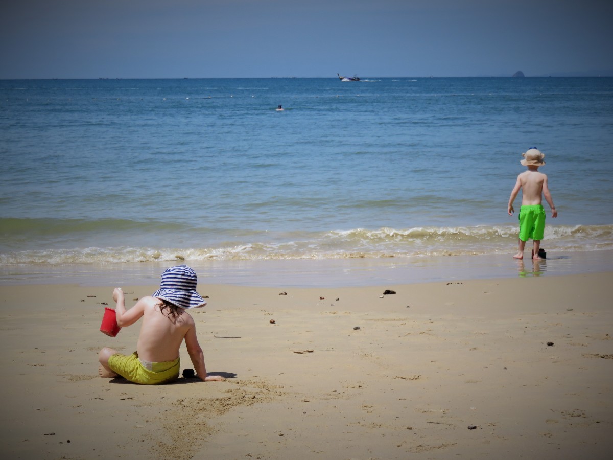 Girl and boy on Ao Nang beach in Thailand