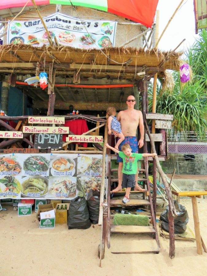 Dad and children at beach bar on Ko Lanta, Thailand