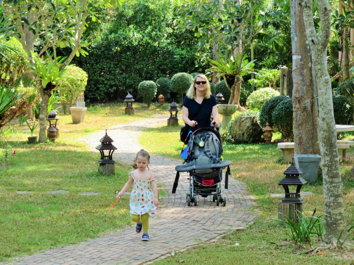 Mum and toddler walking in garden in Ko Lanta, Thailand