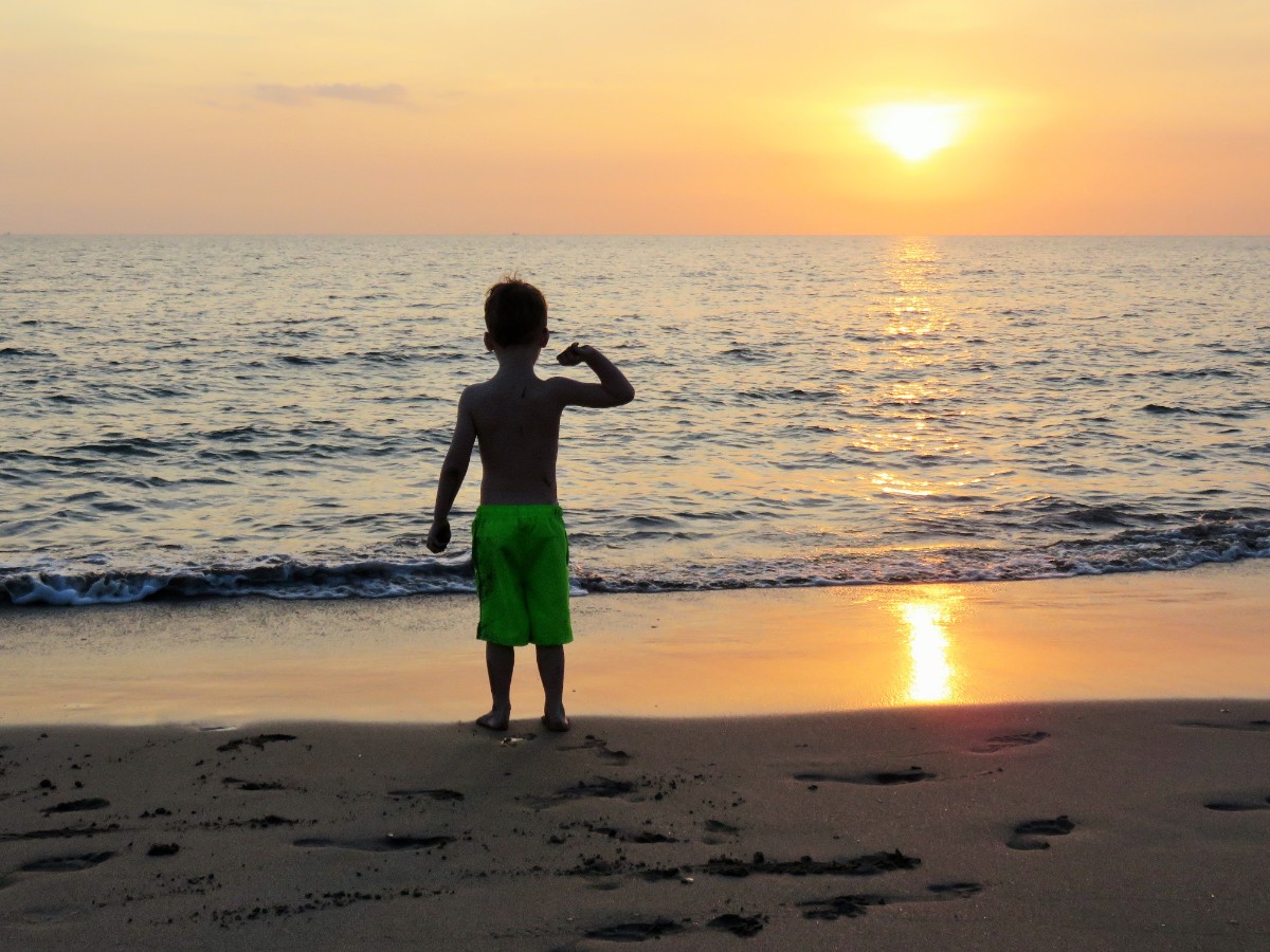 Boy enjoying sunset on Ko Lanta, Thailand