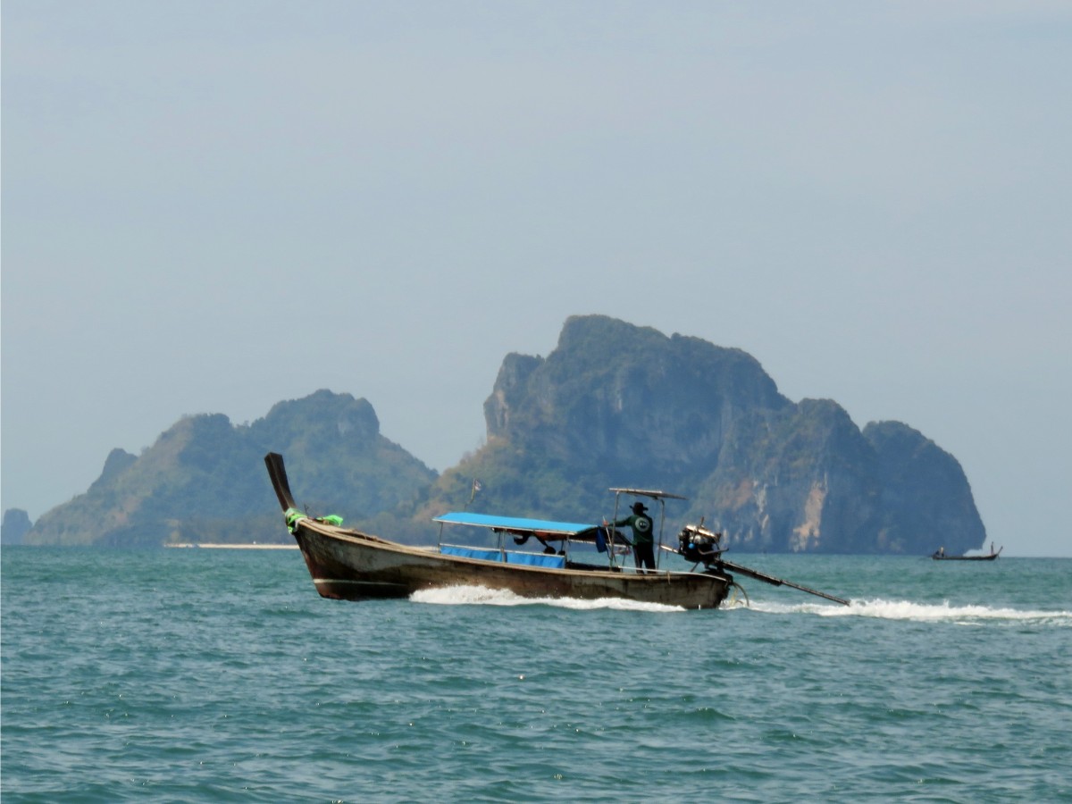 Long-tail boat travelling between Ao Nang and Railay beaches in Thailand
