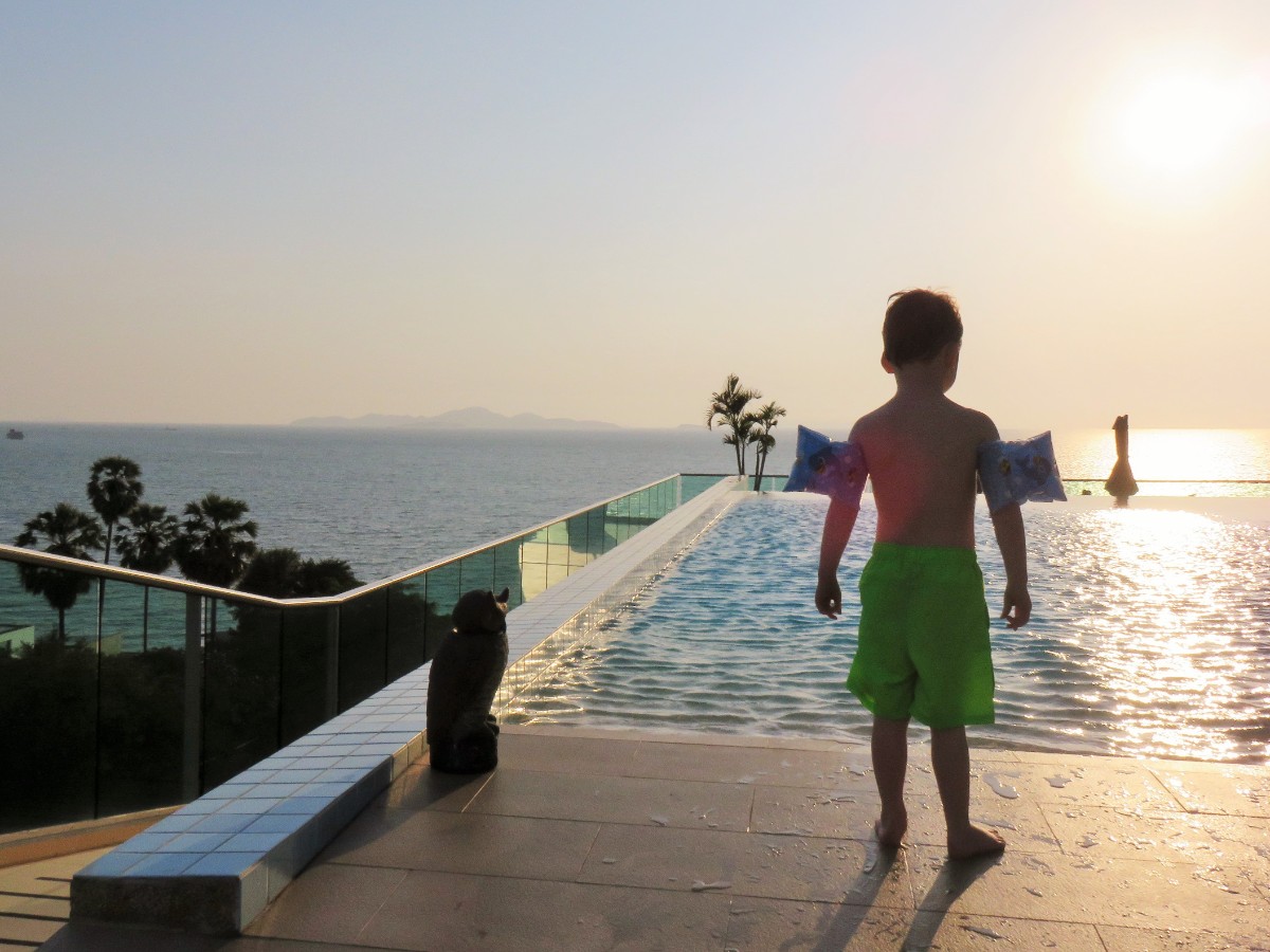 Boy by infinity pool in North Pattaya, Thailand