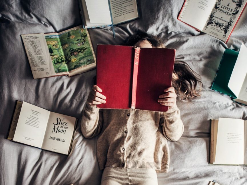 Girl reading feminist books for children