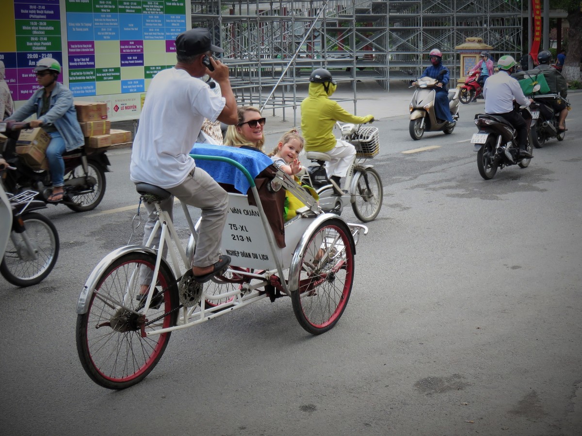 mum and toddler in a rickshaw in Vietnam