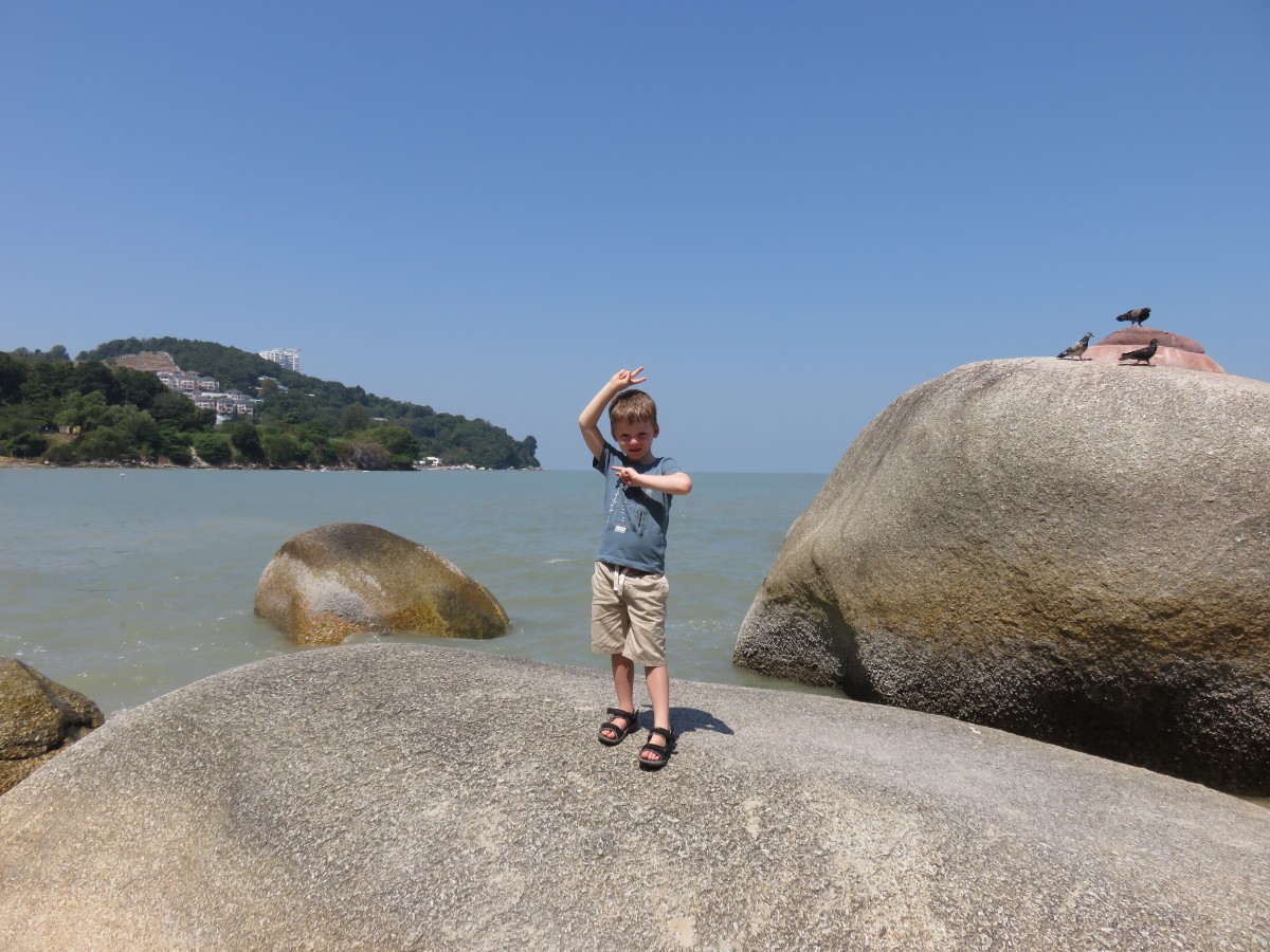 boy on rocks in Penang Malaysia