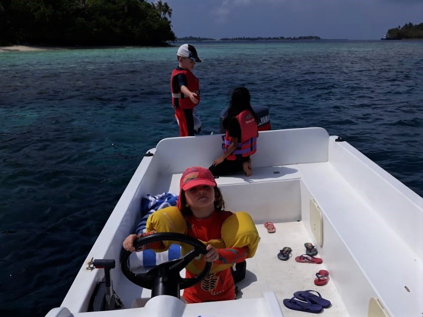 children on boat in the maldives