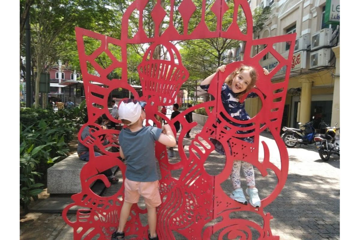 kids playing on red sculpture in Chinatown KL