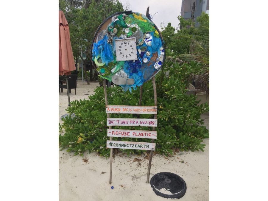 sign on beach in the Maldives about reusing plastic