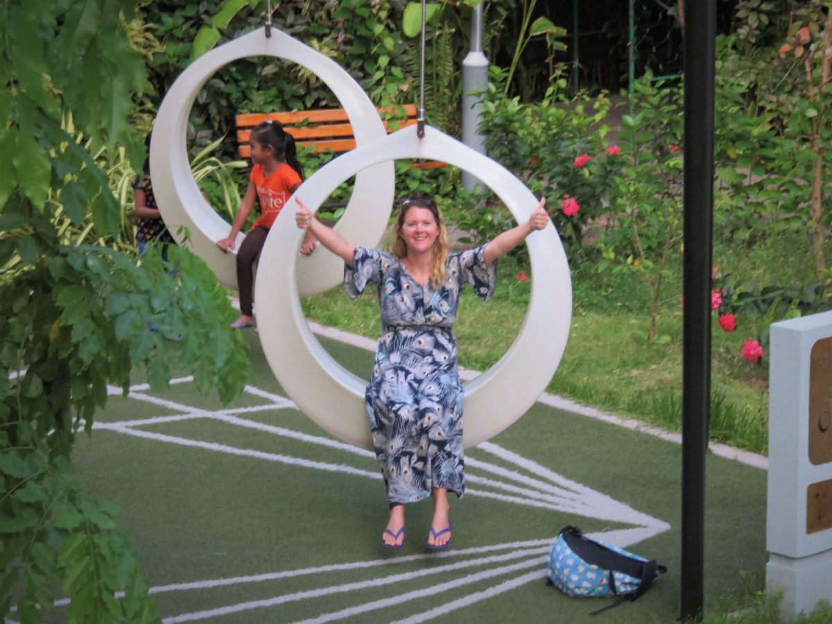 woman on large ring swing in Rasrani Bageecha, Male