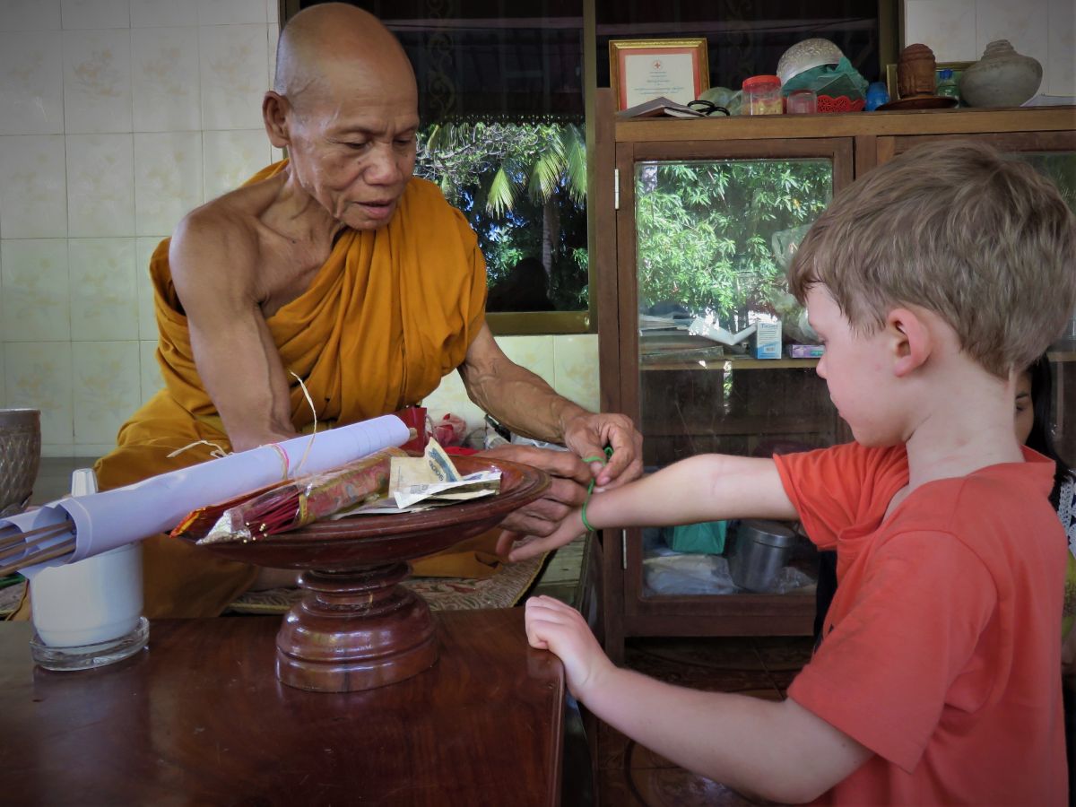 a little boy getting blessed by the monk