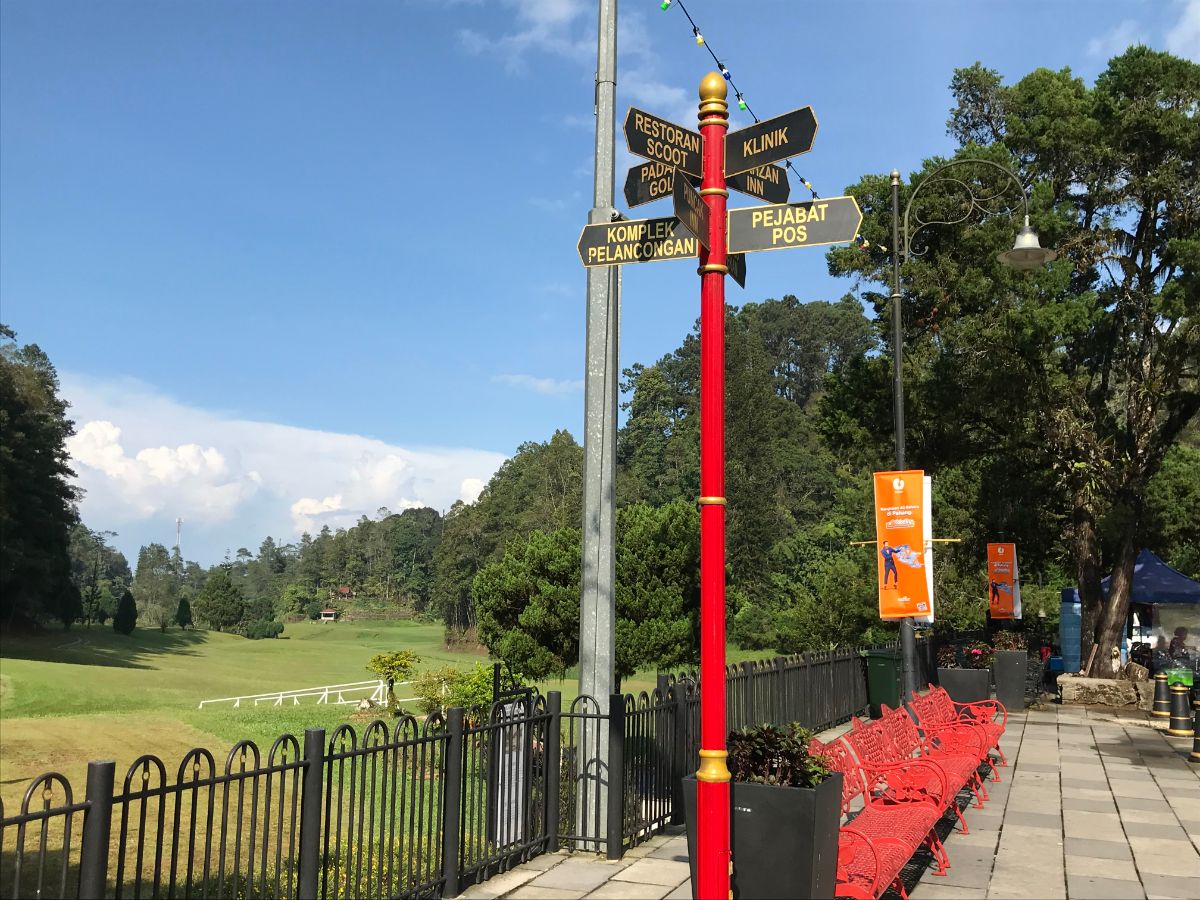 the golf course and red benches in Fraser's Hill