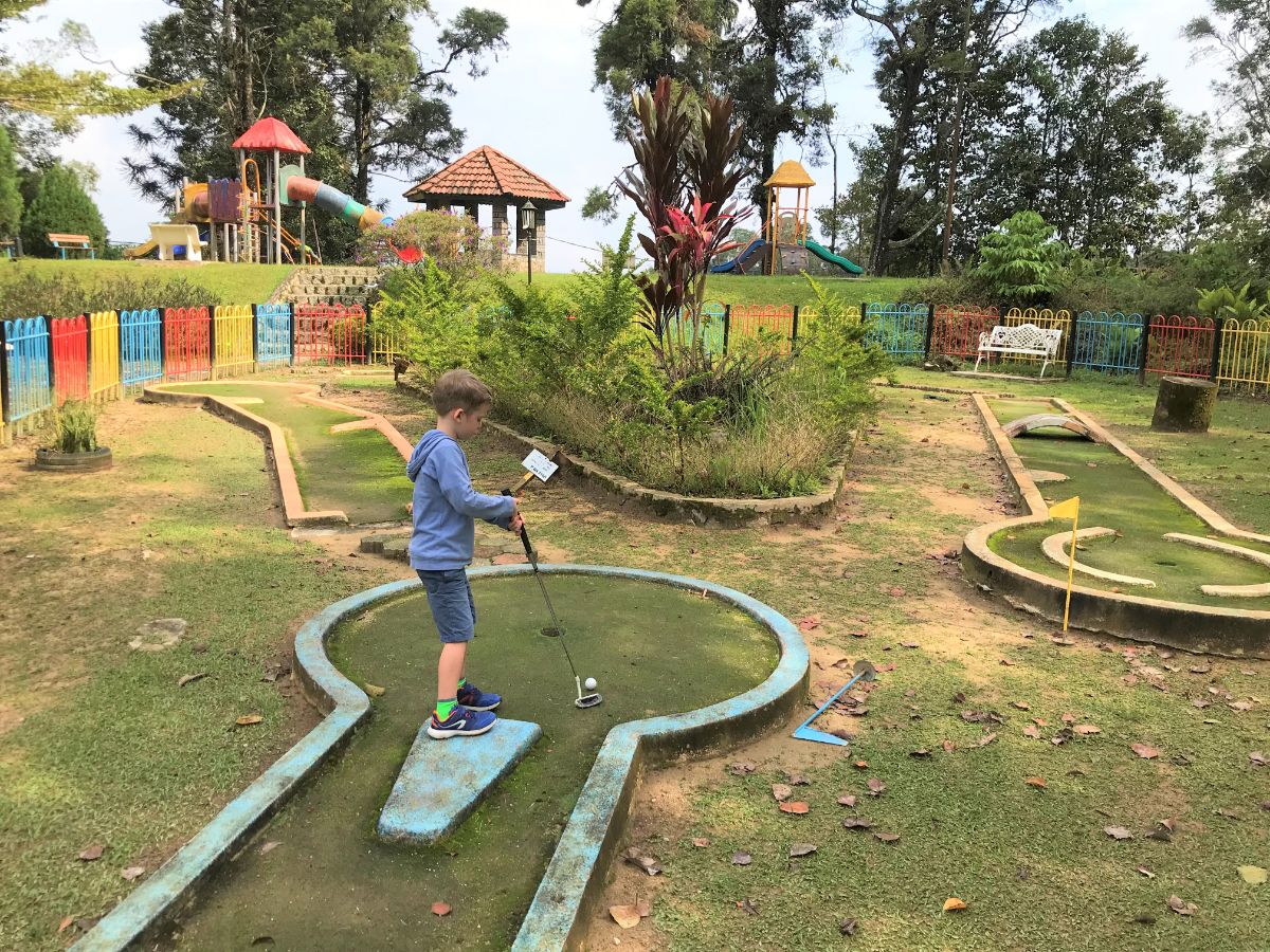 boy playing mini-golf in Fraser's Hill