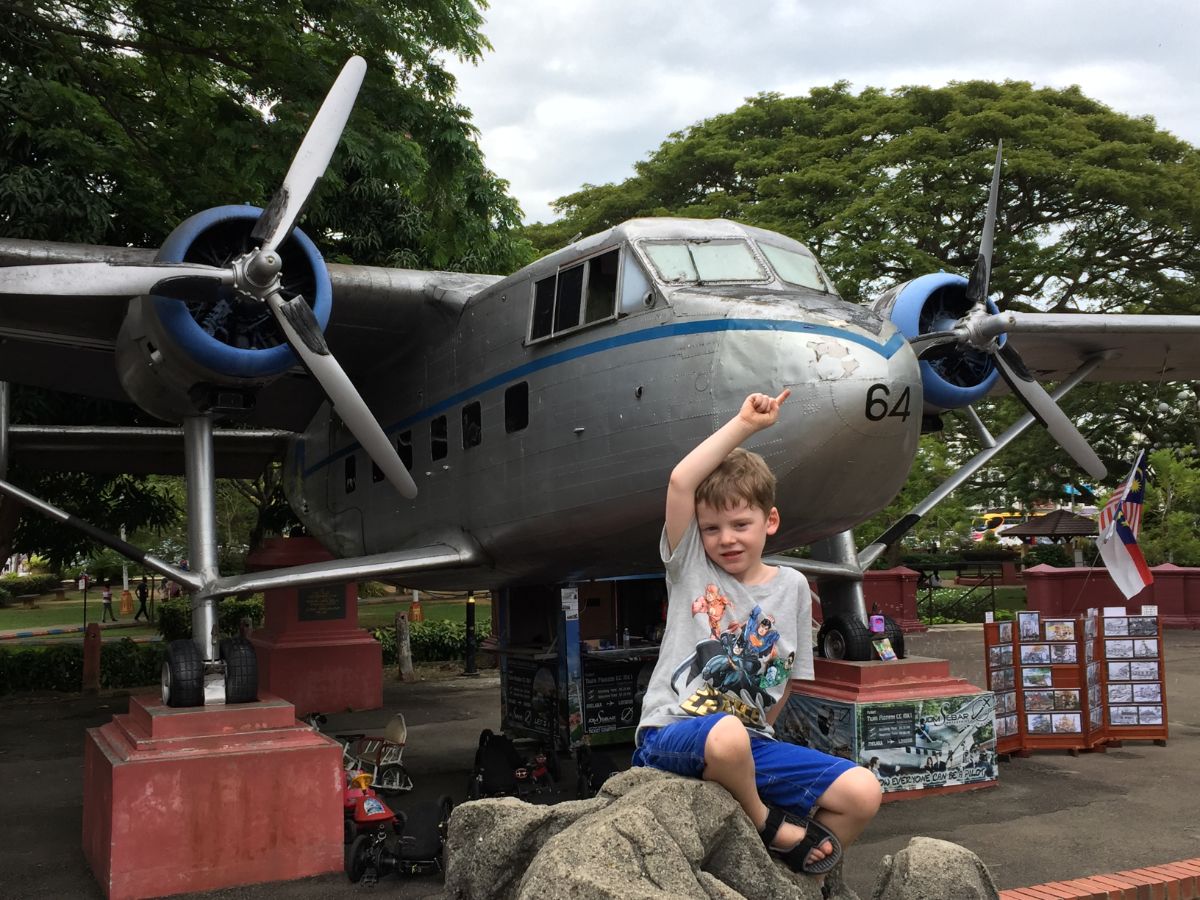 boy posing on aeroplane Melaka