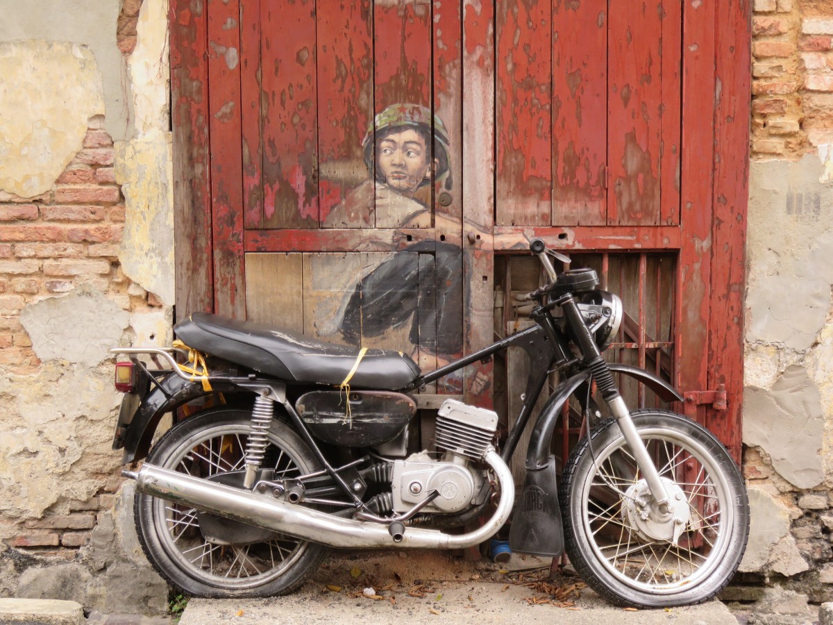A mural of a boy on a motorbike in Georgetown, Penang by Lithuanian artist, Ernest Zacharevi