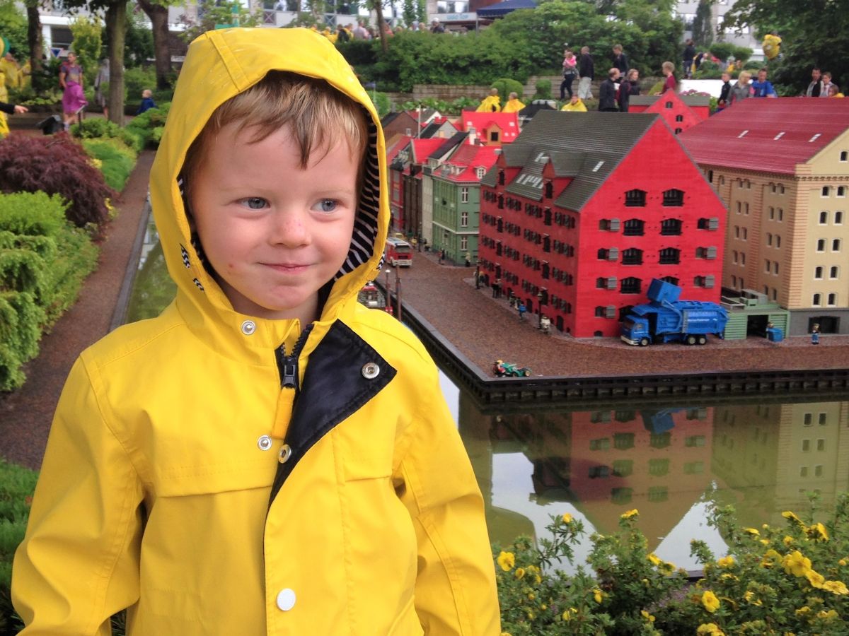 small boy in yellow raincoat in Legoland