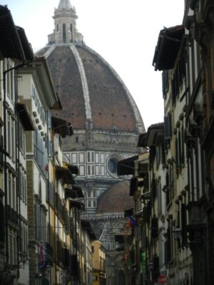 street scene in Florence with the duomo in the distance