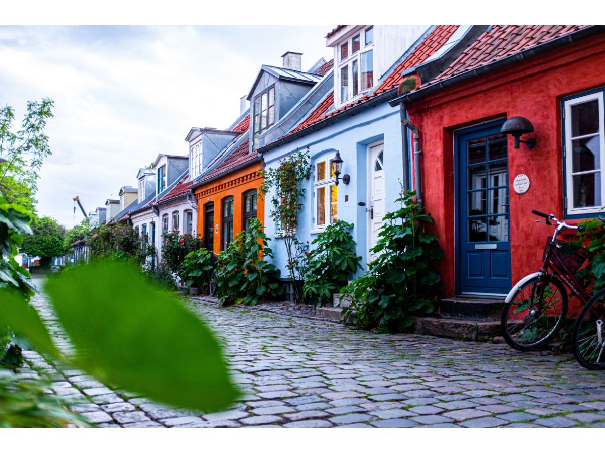 cobbled street in Aarhus, Denmark with bicycle and colourful painted houses