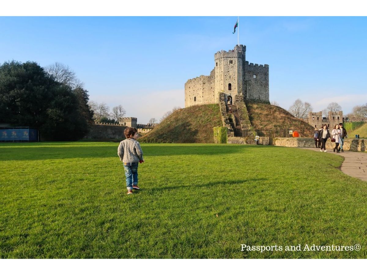 toddler running towards Cardiff Castle in the UK