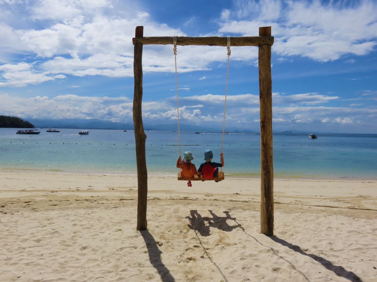 children swinging in Tunku Abdul Rahman Marine Park near Kota Kinabalu, Sabah